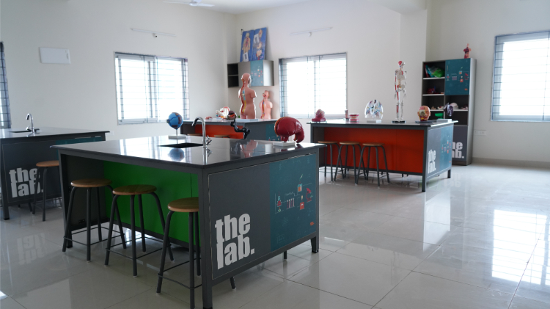 Students conducting experiments in the fully equipped science lab, part of the CBSE curriculum at our Bongloor school.